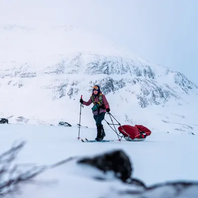 Adventurer pulling a sled on a snowy summit