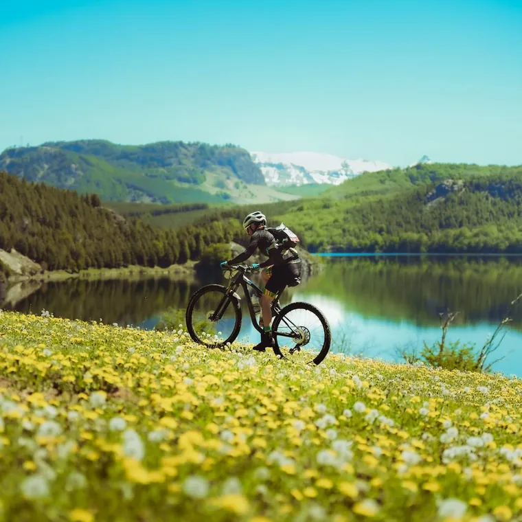 Mountain biker by a mountain lake